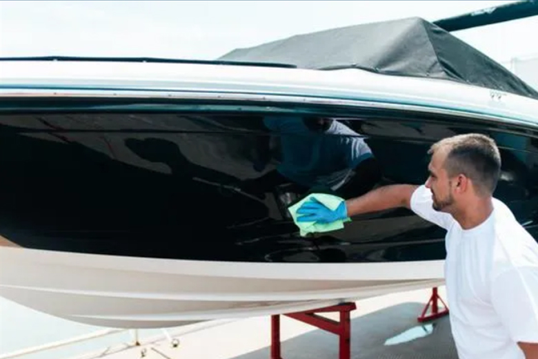 man in a white shirt buffing his boat